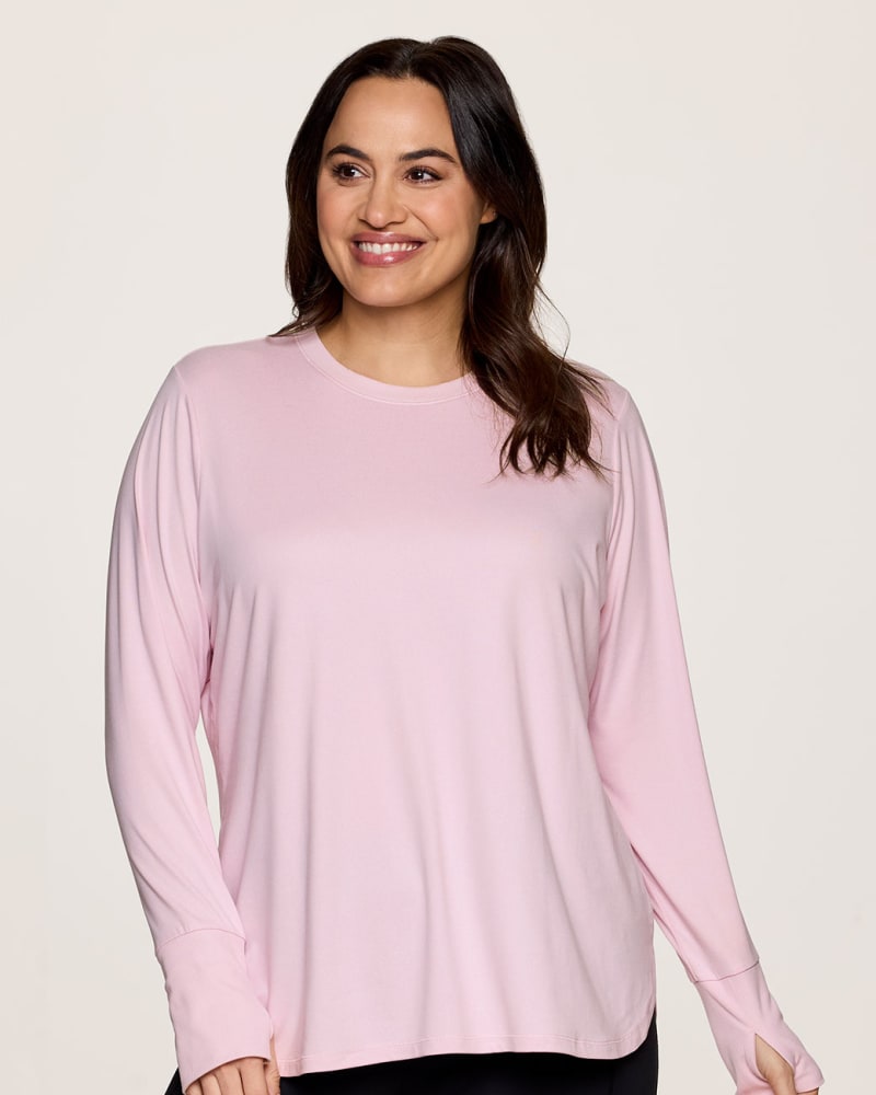 Front of a model wearing a size 1X Plus Studio Super Soft Tunic Tee in Light Pink by RBX Active. | dia_product_style_image_id:341661